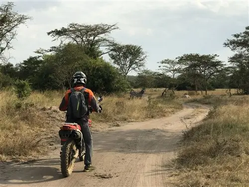 A rider on his Honda XL250 during his moto safari in Uganda.
