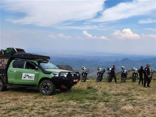 The Moto Support Vehicle, Toyota Hilux Overland, parked besides the adventure motorcycles in Uganda.