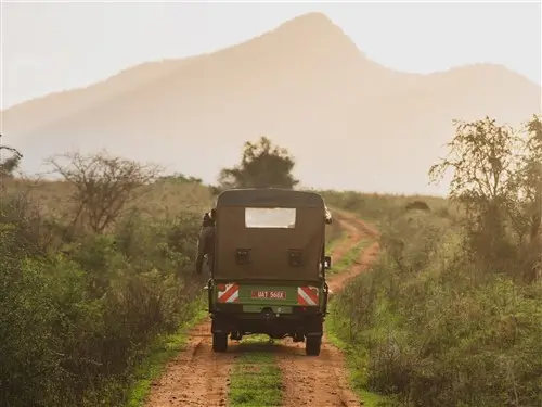 A safari truck on a track in a National Park in Uganda.