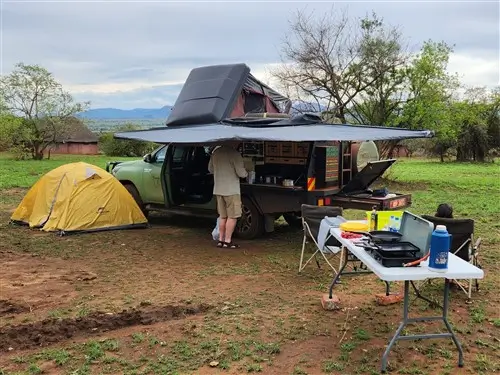 A tourists camping in Kidepo Valley National Park with the Toyota Hilux Overland truck.